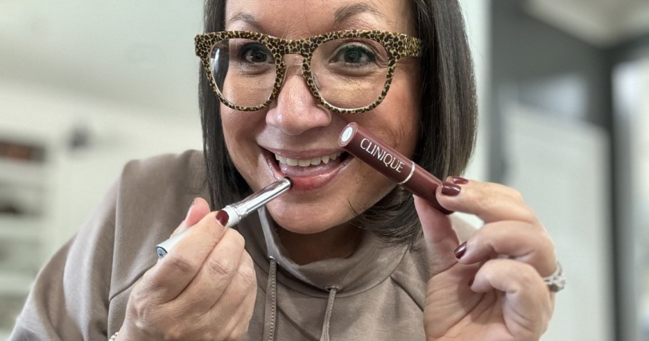 woman using Clinique black honey lipstick