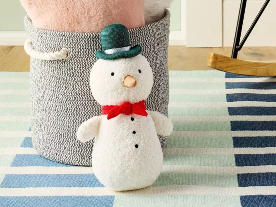 Cloud Island Snowman Plush on rug next to bucket