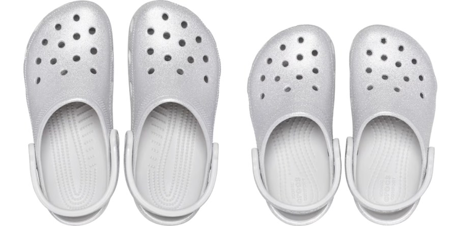 two pairs of silver glitter crocs