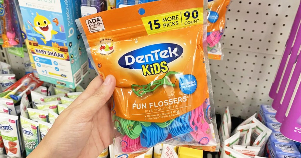 hand holding DenTek Kids Floss Picks 90-Count Bag in store