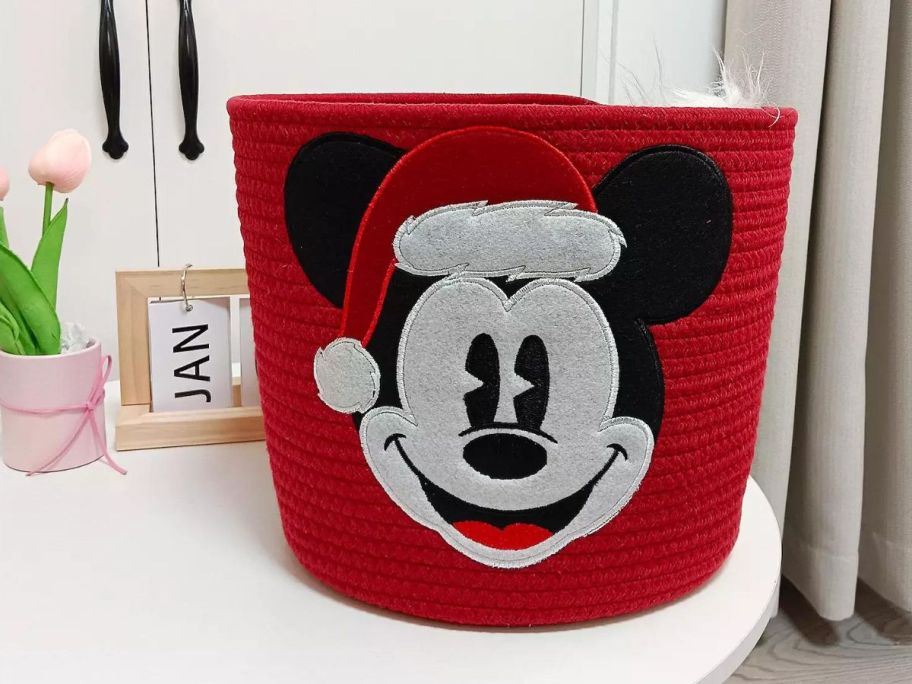 A red Disney's Mickey Mouse Holiday Rope Basket on a table