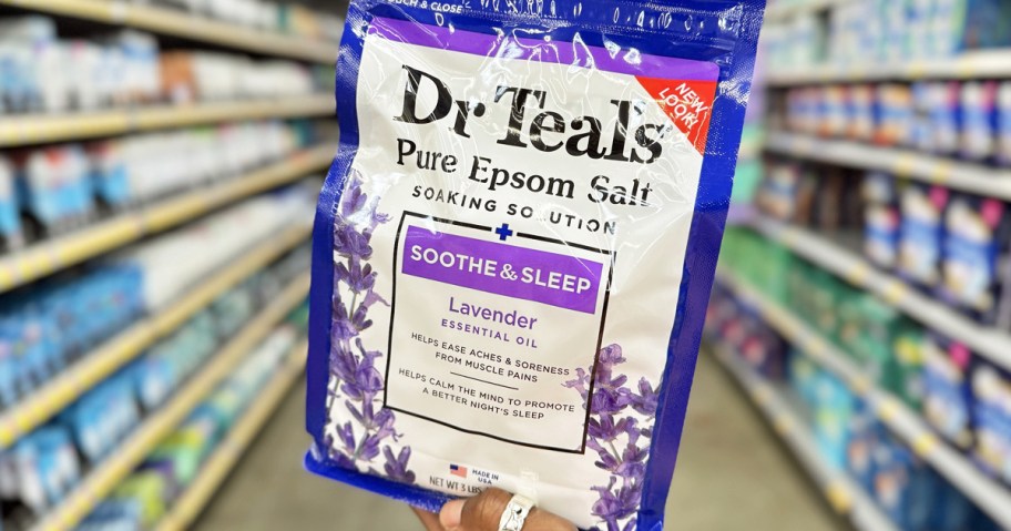 hand holding up a bag of Dr Teal's Soothe & Sleep Lavender Epsom Salt in store