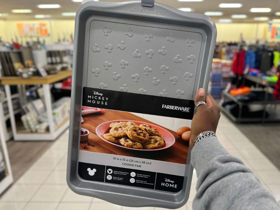 Hand holding up a Farberware Mickey Mouse Cookie Sheet