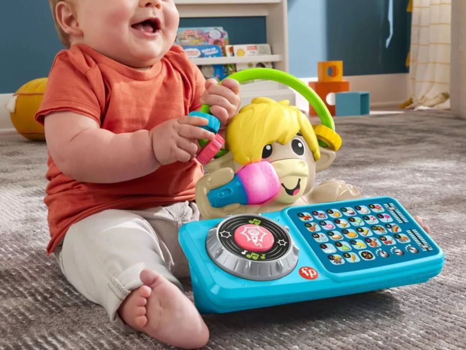 baby playing with Fisher-Price Baby Learning Toy Link Squad A to Z Yak on floor