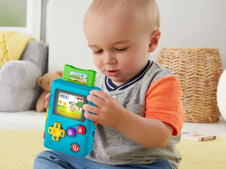 kid playing with Fisher-Price Laugh & Learn Lil' Gamer Pretend Video Game Learning Toy