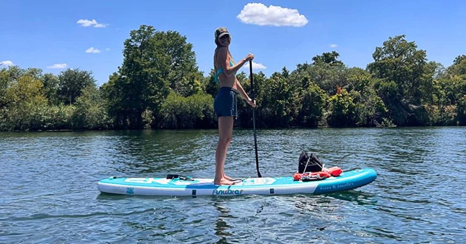 Woman in a lake standing on a Funwater Inflatable Paddle Board