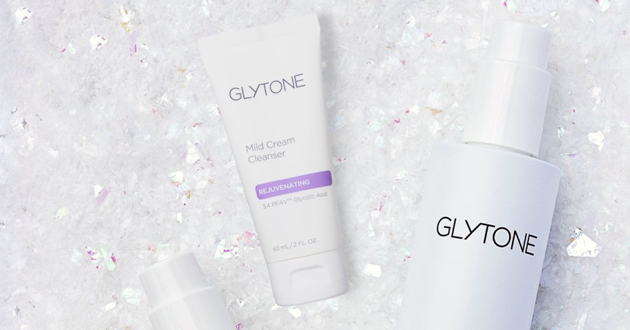 Glytone cleansers on top of white glitter background