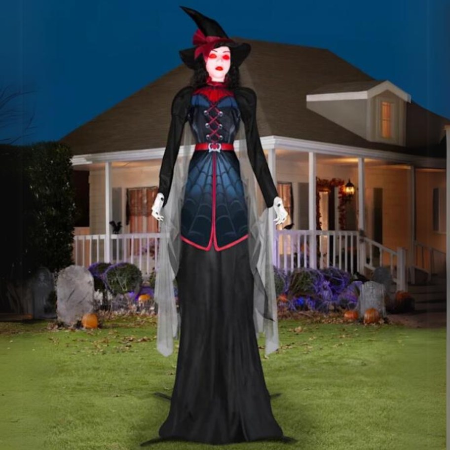 large animatronic Halloween witch outside a house 