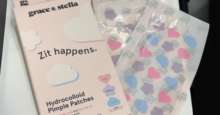 pink box of Grace & Stella pimple patches with sheets of them beside it