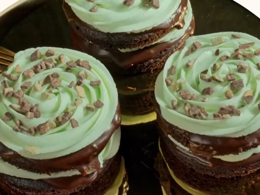 chocolate cookies with green icing on a plate