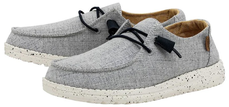 pair of grey sneakers with black laces