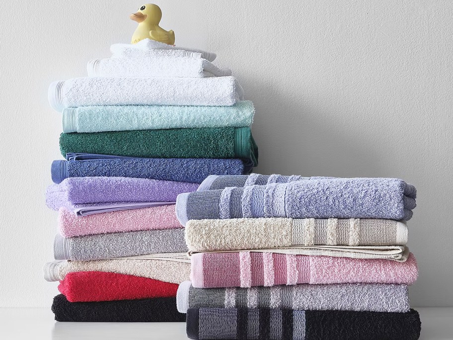 stack of folded bath towels in various colors