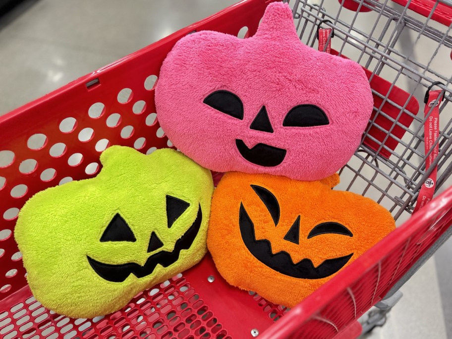 neon green, pink, and orange pumpkin throw pillows in target shopping cart