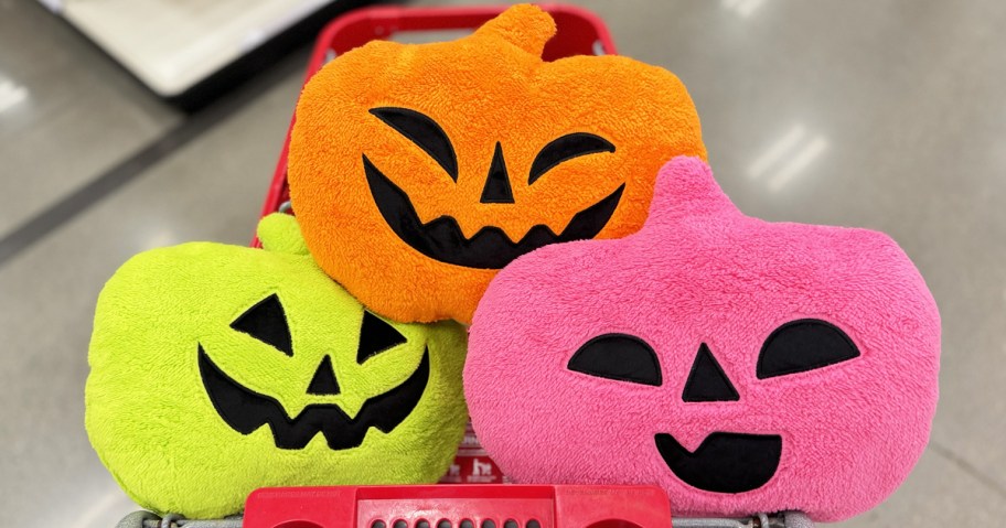 neon green, pink, and orange pumpkin throw pillows in target shopping cart