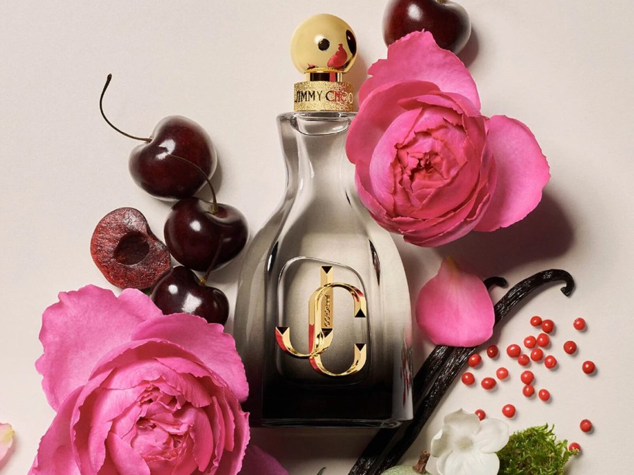 bottle of Jimmy Choo I Want Choo Forever surrounded by roses, cherries, and vanilla beans