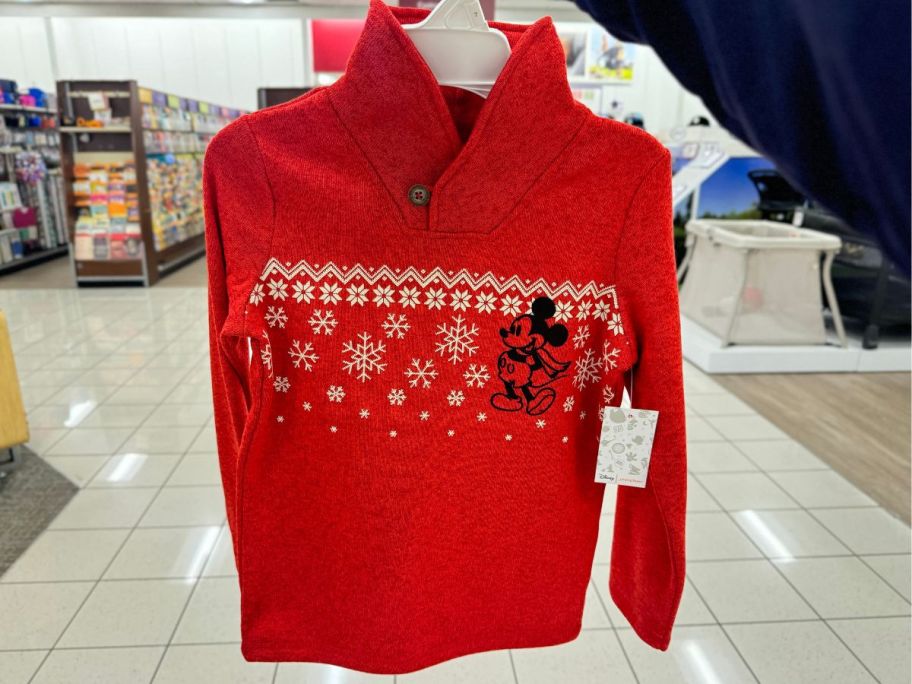 Jumping Beans Disney's Mickey Mouse Boys Shawl Collar Holiday Sweater hanging in store