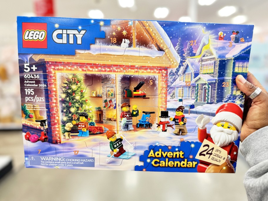 holding up a LEGO City Advent Calendar in store