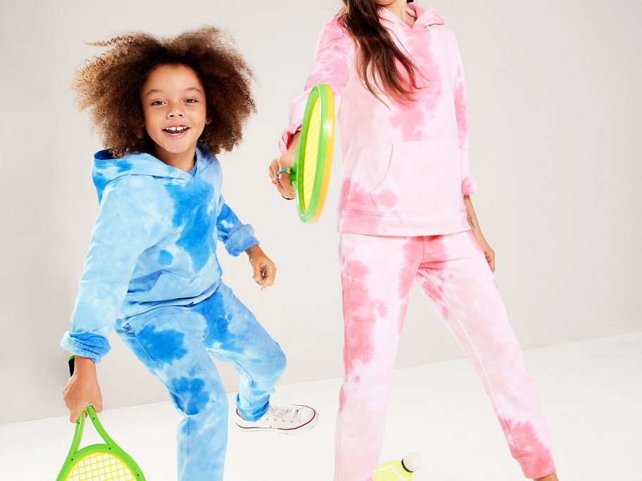 two kids in matching blue and pink tie dye hoodie and jogger sets