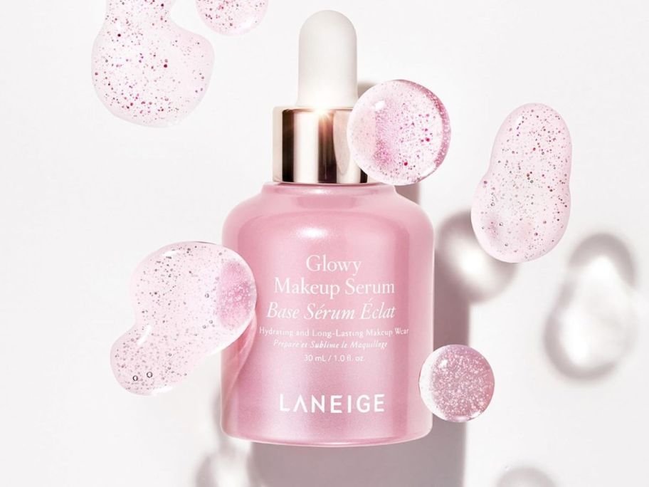 Laneige Glowy Makeup Serum with dots of serum around it