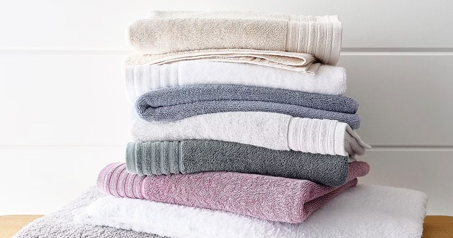 stack of folded bath towels in various colors