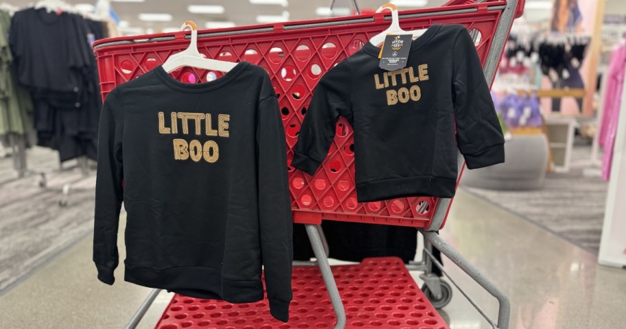 two little boo sweatshirts hanging on target cart