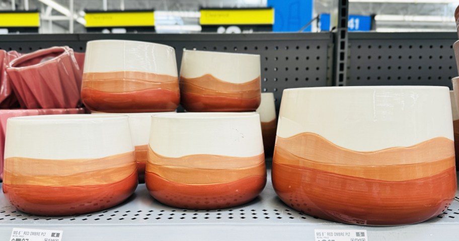 white and red ombre planters on store shelf