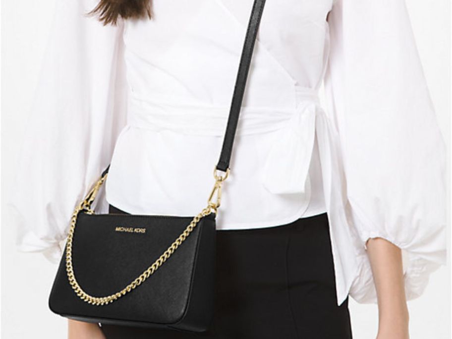 Woman wearing a Michael Kors Jet Set Medium Saffiano Leather Crossbody Bag