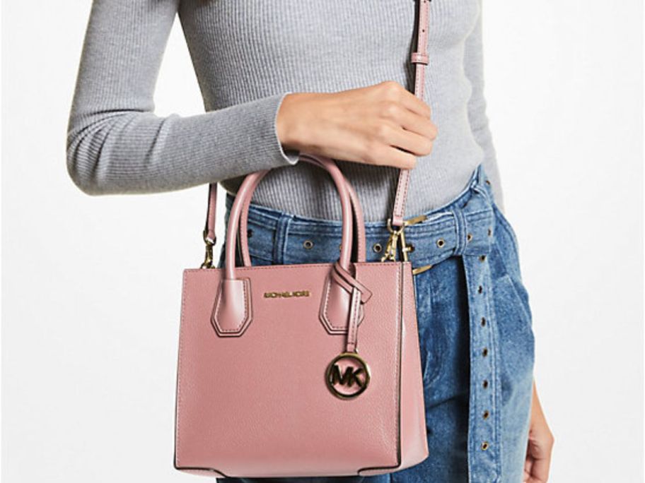 Woman wearing a Michael Kors Mercer Medium Pebbled Leather Crossbody Bag