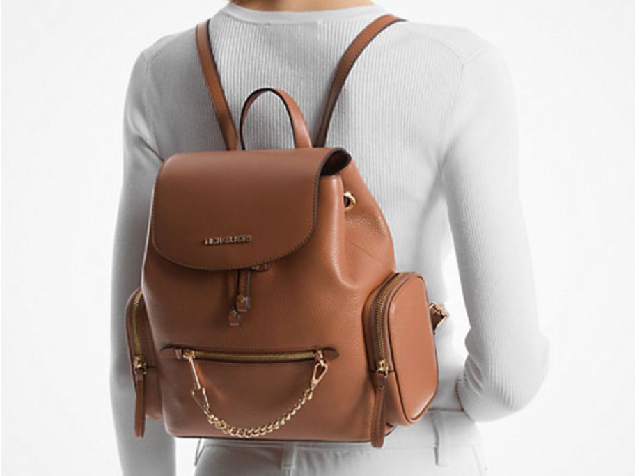 Woman wearing a Michael Kors Jet Set Medium Pebbled Leather Backpack