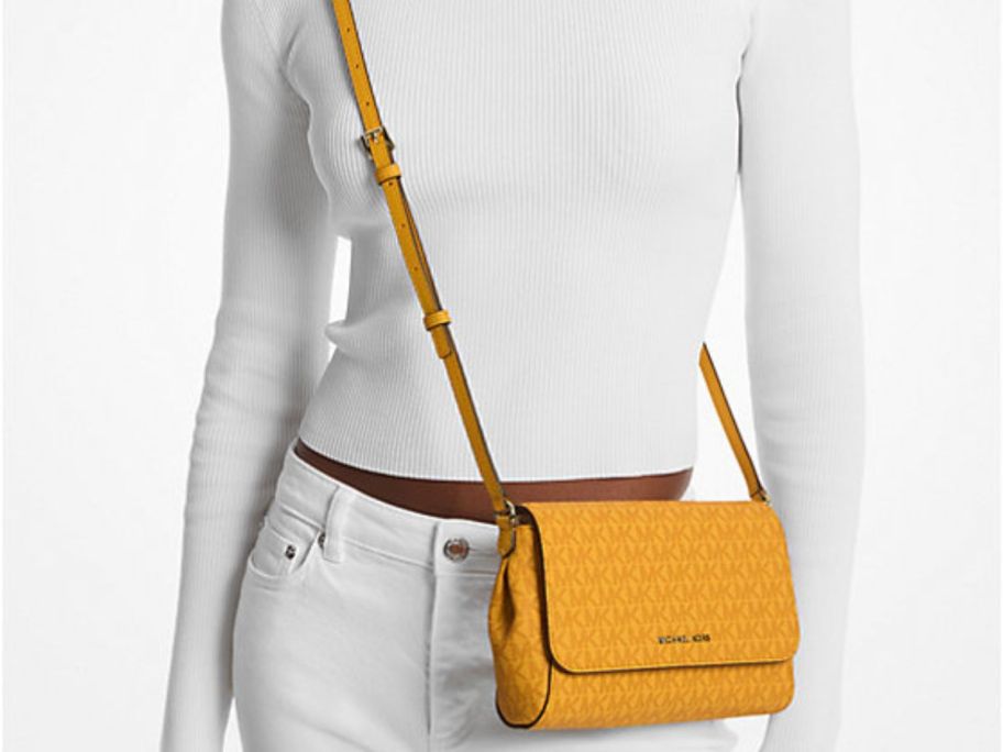 Woman wearing a Michael Kors Medium Logo Convertible Crossbody Bag