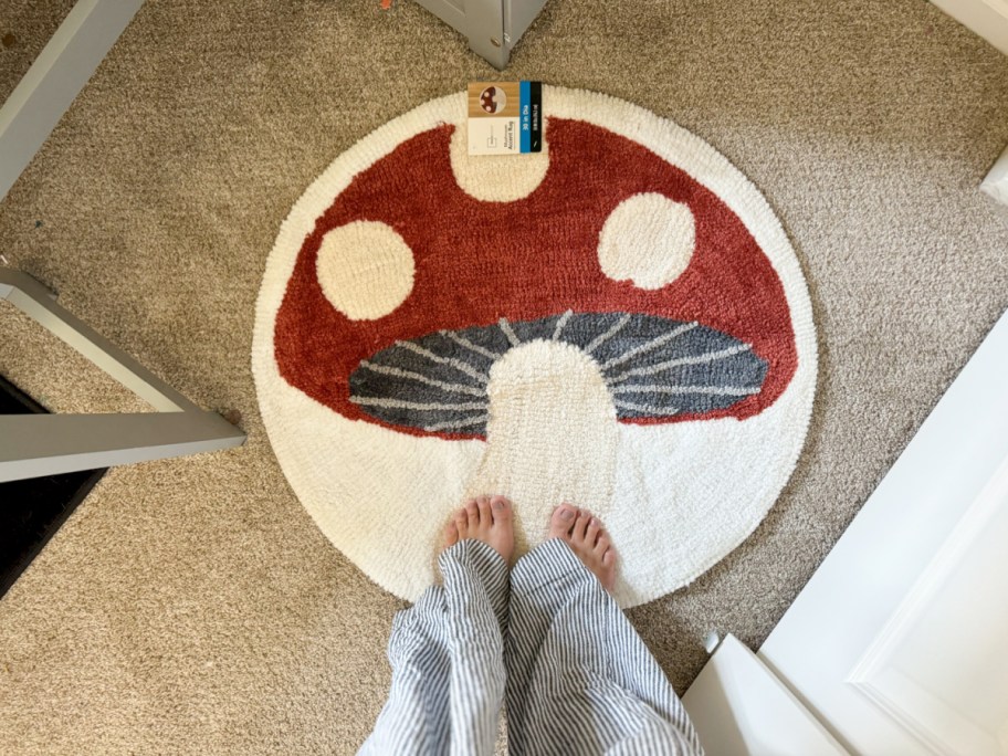 Woman stepping on a rug shaped like a mushroom, one of the trendy Walmart college finds