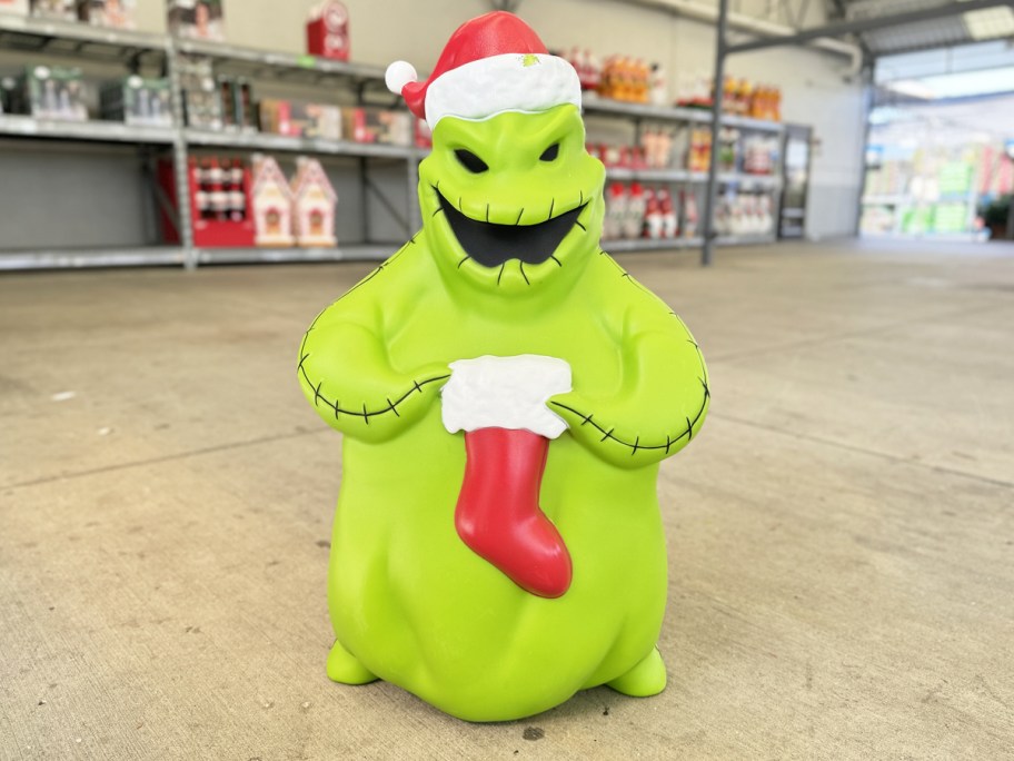 green Nightmare Before Christmas Oogie 32" Christmas Blow Mold holding a stocking