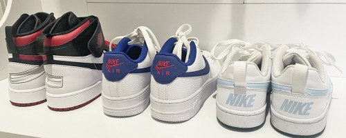 nike shoes lined up in a row on white bench