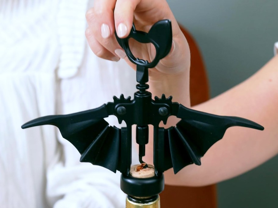 using a black bat-shaped wine bottle opener