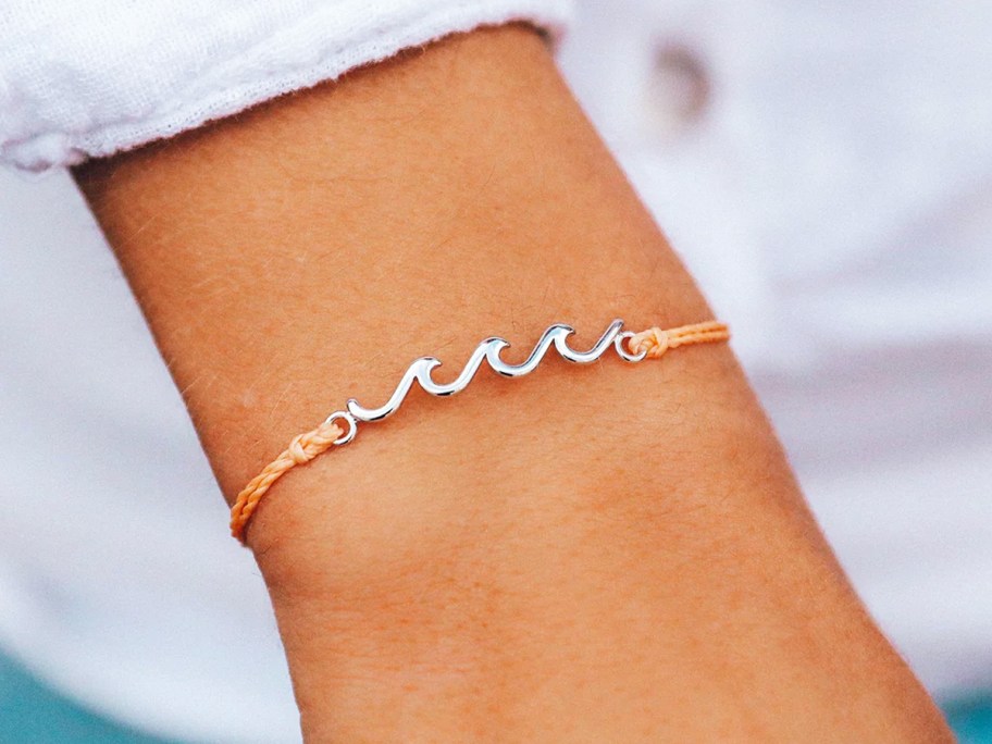 arm with a silver wave bracelet