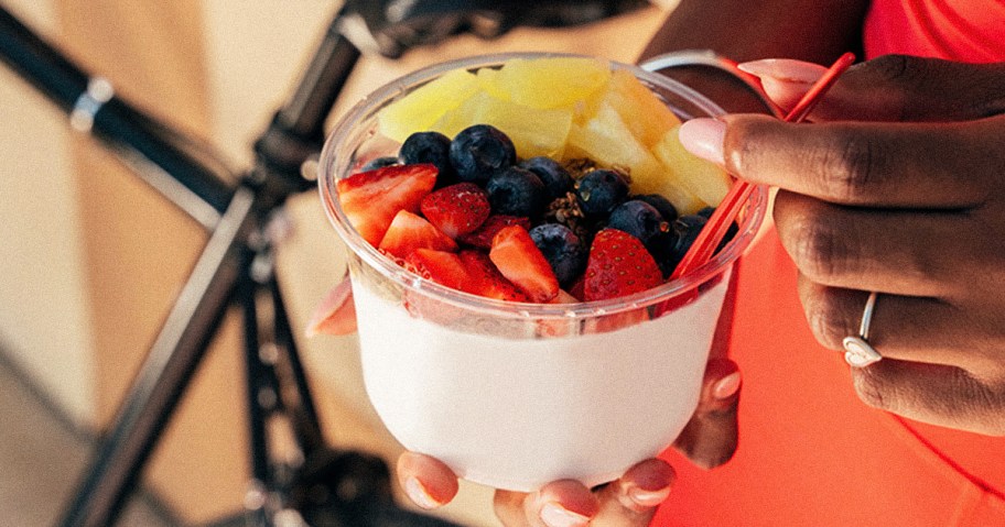 hands holding a smoothie bowl