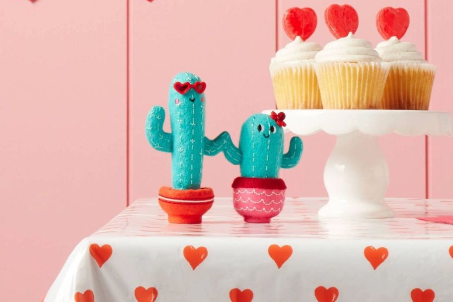 two felt cactus figurines on a table top