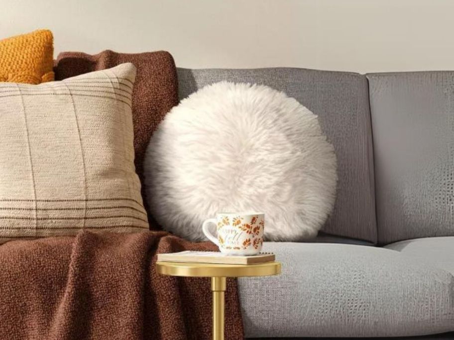 Threshold Long Faux Fur Round Throw Pillow on couch