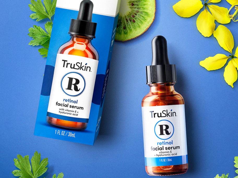 bottle and box of TruSkin Retinol near flowers