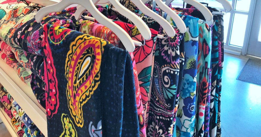 printed throw blankets on hangers in store