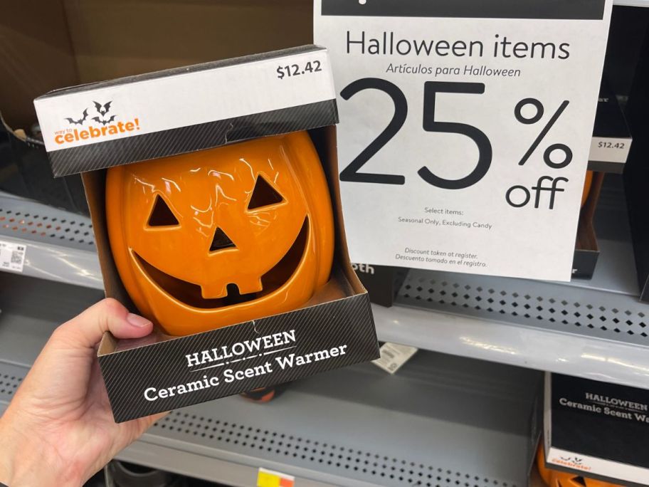 Way To Celebrate Halloween Orange Ceramic Pumpkin Indoor Electric Wax Warmer in hand in store