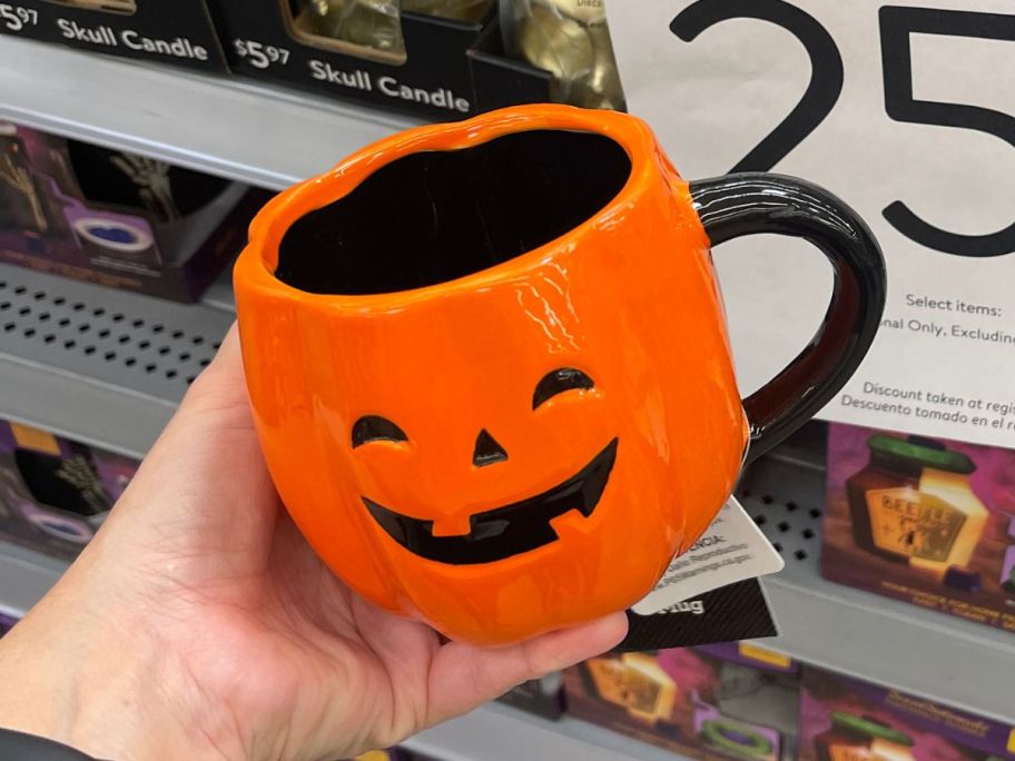 Way To Celebrate Halloween Orange Pumpkin Ceramic Mug in hand in store