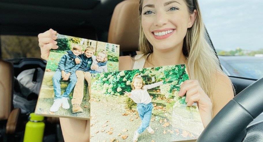 Woman holding woodpanels while sitting in the car