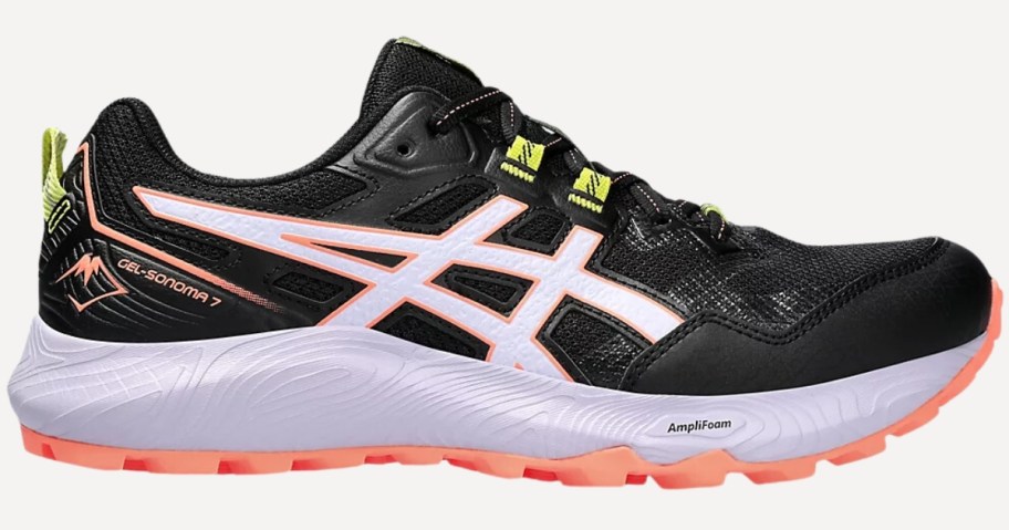 a women's Asics running shoe in black with white, orange, and yellow accents