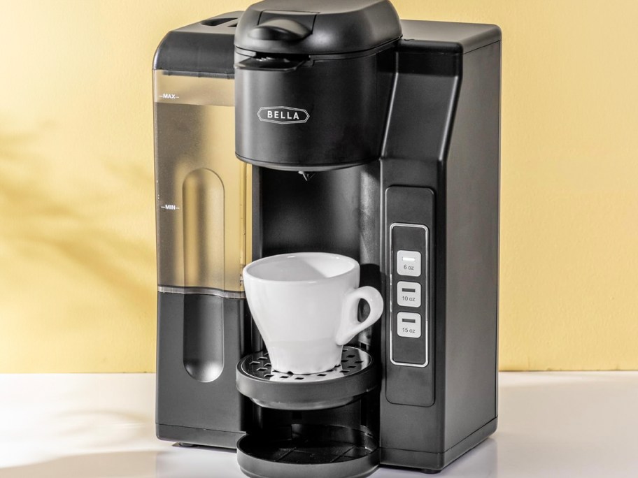 black bella coffee maker on counter with white mug