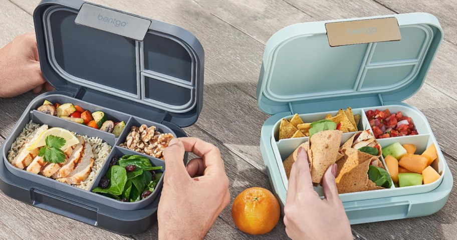 two hands grabbing out of lunchboxes