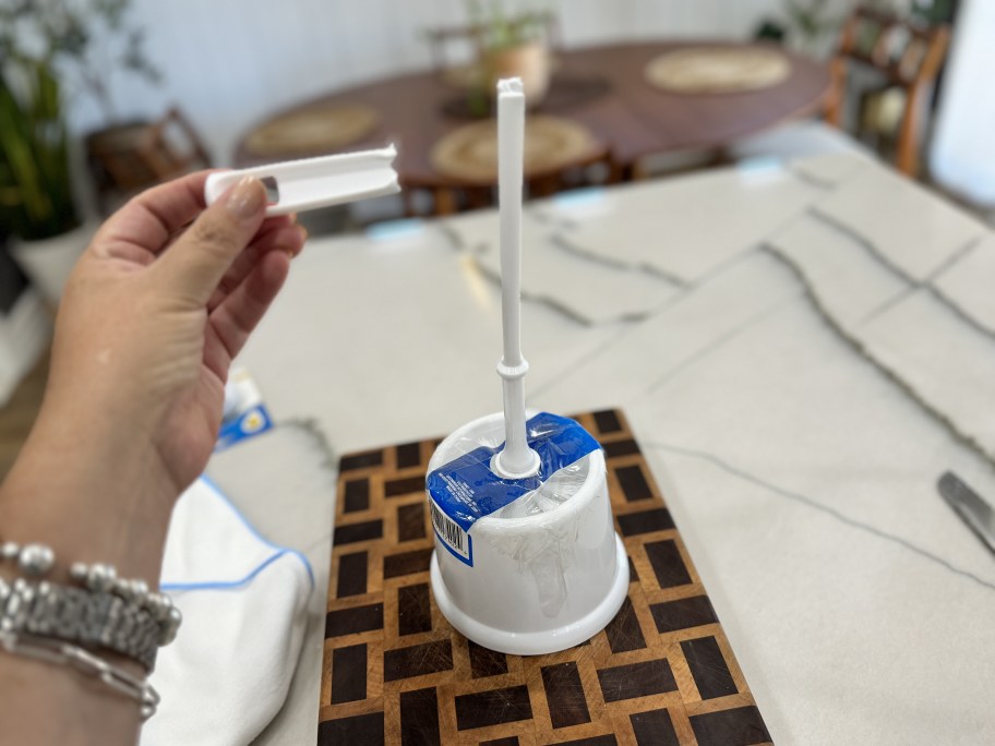 cutting the top of a toilet brush