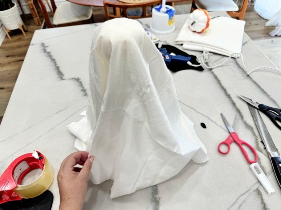 cutting up a pillowcase to make tabletop ghosts 