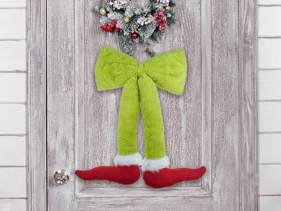 green bow with Grinch legs hanging on door