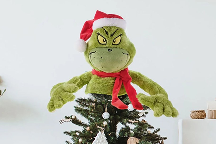 plush Grinch on top of Christmas tree